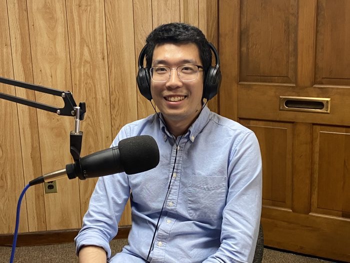Minghao Qiu recording in a podcast studio